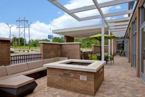 an outdoor patio with a couch and an umbrella at SpringHill Suites by Marriott Orangeburg in Orangeburg
