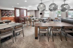 a restaurant with tables and chairs in a room at SpringHill Suites Scottsdale North in Scottsdale