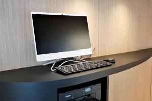 a computer monitor and a keyboard and mouse on a desk at Fairfield by Marriott Osaka Namba in Osaka
