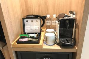 a desk with a coffee maker and a microwave at Fairfield by Marriott Osaka Namba in Osaka
