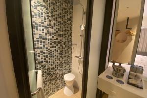 a bathroom with a shower with a glass door at Fairfield by Marriott Osaka Namba in Osaka