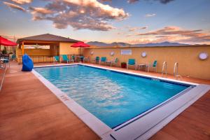 a pool at a hotel with chairs and tables at TownePlace Suites by Marriott Missoula in Missoula