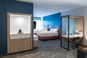a hotel room with a bed and a desk at SpringHill Suites by Marriott Overland Park Leawood in Overland Park