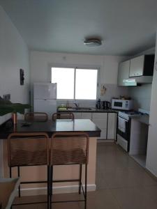 a kitchen with a table and two chairs in it at Hermosa energía in San Salvador de Jujuy