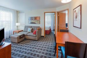 a living room with a couch and a bed at TownePlace Suites Minneapolis West/St. Louis Park in Saint Louis Park