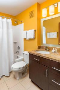 a bathroom with a toilet and a sink and a mirror at TownePlace Suites Phoenix North in Phoenix
