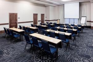 a conference room with tables and chairs and a whiteboard at Courtyard by Marriott Richmond Downtown in Richmond