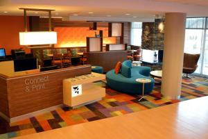 a lobby of a hotel with a couch and a table at Fairfield Inn & Suites by Marriott Stafford Quantico in Stafford