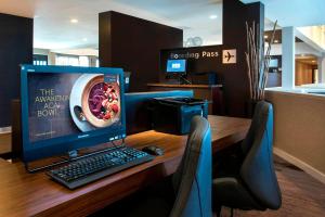 a desk with a computer monitor and a keyboard and mouse at Courtyard by Marriott Poughkeepsie in Poughkeepsie