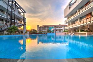 a large swimming pool in the middle of a building at Hotel Somadevi Angkor Boutique and Resort in Siem Reap