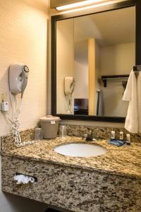 a bathroom with a sink and a mirror and a phone at Fairfield Inn & Suites Jacksonville Airport in Jacksonville