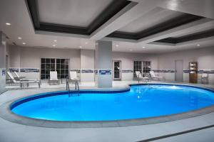 a large pool with blue water in a hotel room at Delta Hotels by Marriott Norfolk Airport in Norfolk