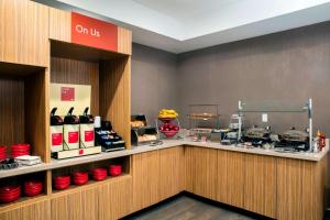 a restaurant with a counter with red bowls on display at TownePlace Suites by Marriott Miami Homestead in Homestead