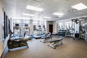 a gym with several treadmills and cardio machines at Courtyard by Marriott Edmonton West in Edmonton