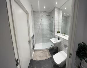 a bathroom with a tub and a sink and a toilet at Luxury one bed apartment in Manchester city center in Manchester