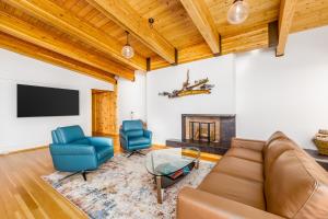 a living room with a couch and chairs and a tv at Downtown Contemporary - Full Property in Anchorage