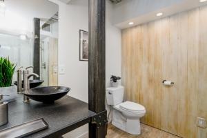 a bathroom with a sink and a toilet and a counter at Downtown Contemporary - Full Property in Anchorage