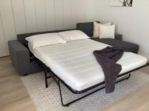 a bed sitting on top of a couch at In the Heart of Port Melbourne in Melbourne