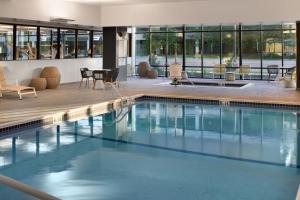 una gran piscina con sillas y mesas en un edificio en Element Bloomington Mall of America en Bloomington