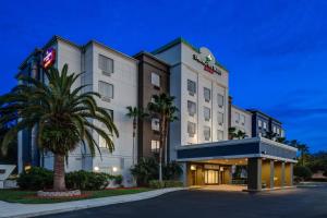 a hotel with a palm tree in front of a building at SpringHill Suites by Marriott Orlando North-Sanford in Sanford