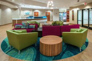 a lobby with couches and tables in a hospital at SpringHill Suites by Marriott Orlando North-Sanford in Sanford