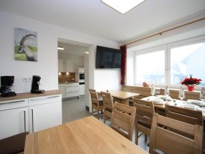 a kitchen and dining room with a table and chairs at Alpensteinbock Mauterndorf II in Mauterndorf