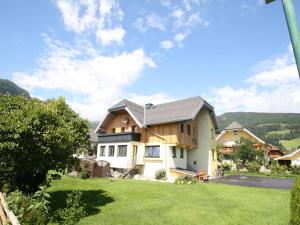 a house with a green lawn in front of it at Alpensteinbock Mauterndorf II in Mauterndorf