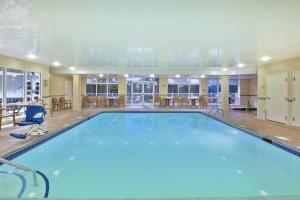 a pool in a hotel room with tables and chairs at SpringHill Suites Minneapolis-St. Paul Airport/Eagan in Eagan