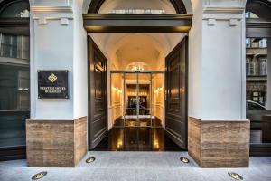 a hallway of a building with two doors and a entrance at Prestige Hotel Budapest in Budapest