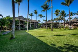 a group of palm trees in front of a resort at Kanaloa At Kona 701 in Kailua-Kona