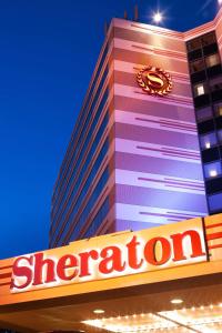 a building with a star department sign in front of it at Sheraton Suites Chicago O'Hare in Rosemont