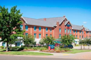 a large red brick building with blue windows at TownePlace Suites by Marriott Rock Hill in Rock Hill