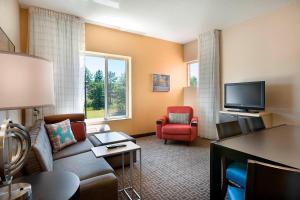 a living room with a couch and a tv at TownePlace Suites by Marriott Rock Hill in Rock Hill