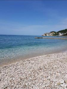 a beach with rocks and the ocean in the background at Summer Beach House in Ulcinj +11 photos