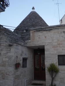 a stone building with a door and a roof at Trulli migrado in Alberobello