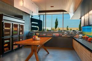 a kitchen with a wooden table in front of a counter at Aloft Vaughan Mills in Vaughan