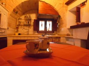 a vase sitting on top of a table in a kitchen at Trulli migrado in Alberobello +8 photos