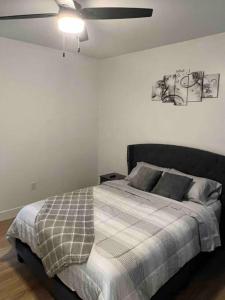 a bedroom with a bed and a ceiling fan at South Charlotte Most Wanted in Charlotte