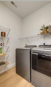 a kitchen with a stove and a refrigerator at South Charlotte Most Wanted in Charlotte