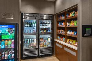 a drink refrigerator in a grocery store with drinks at SpringHill Suites by Marriott Syracuse Carrier Circle in East Syracuse