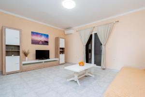 a living room with a couch and a tv at Apartments with a parking space Kraj, Pasman - 819 in Tkon