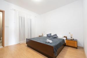 a bedroom with a bed with a towel on it at Apartments with a parking space Kraj, Pasman - 819 in Tkon