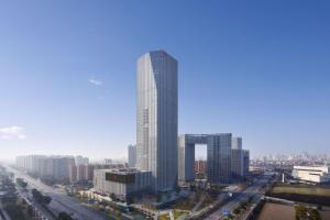 a tall building in the middle of a city at Jinhua Marriott Hotel in Jinhua