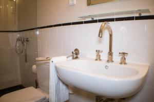 a bathroom with a sink and a toilet at Casas dos Avos in Vale de Cambra