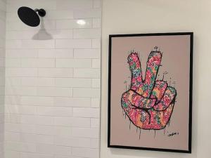 a picture of a pink hand on a wall at Vine City Home - Duplex - 3 Mins From GWCC & Mercedes- Benz Stadium in Atlanta