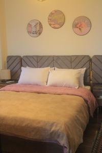 a bedroom with a large bed with two pillows at Mermaid House in Alexandria