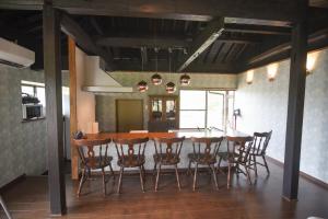 a kitchen and dining room with a table and chairs at 山鹿師蔵 in Yamaga