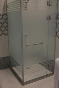 a shower with a glass door in a bathroom at Mermaid House in Alexandria