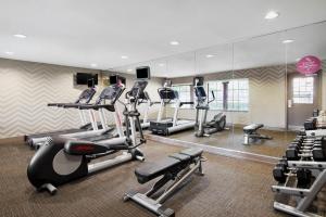 a gym with several tread machines and a mirror at Residence Inn Temple in Temple