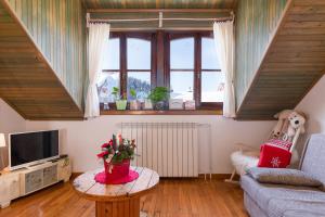 a living room with a couch and a table at Apartments with a parking space Delnice, Gorski kotar - 20297 in Delnice